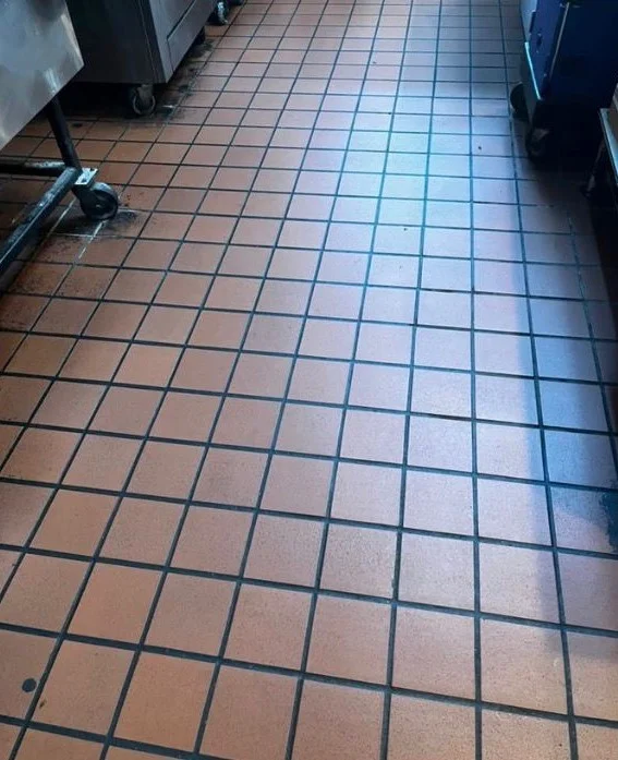 Grimy commercial kitchen tile floor before a cleaning in Tampa, FL