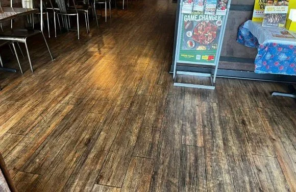 Dull, dirty restaurant dining room floor before a commercial cleaning in Tampa, FL